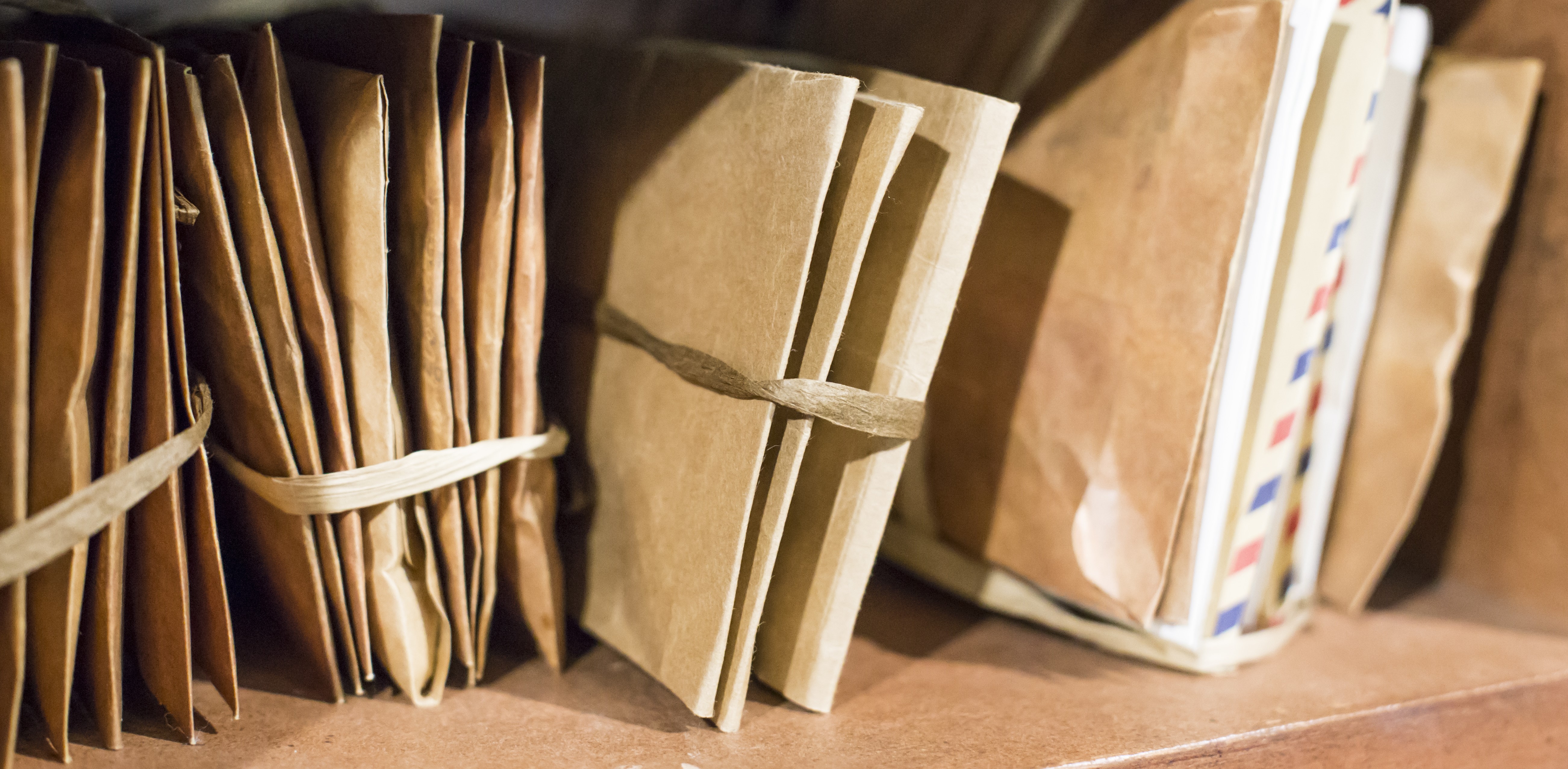 Stack of old letters on a wooden bookcase. Old mail of the post office