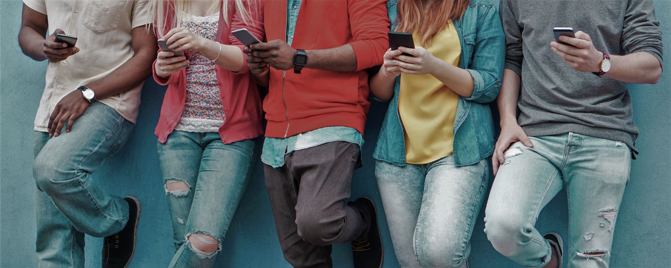 Group of people looking at mobile devices.